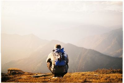 Rear view of women sitting on mountain