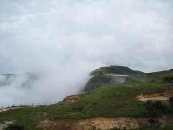 Scenic view of waterfall against sky