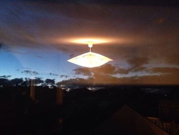 Illuminated built structure against sky at night