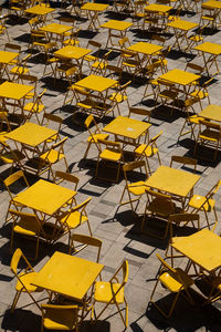 High angle view of empty chairs and table outdoors