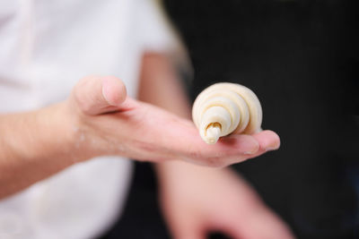 Close-up of human hand holding seashell