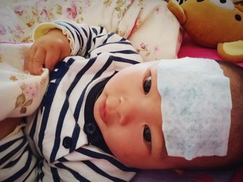 Close-up portrait of cute baby sleeping on bed