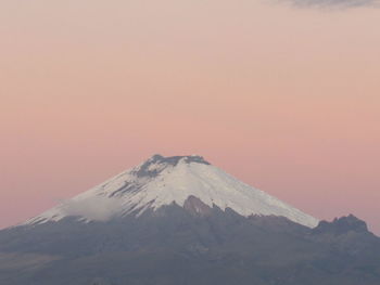 Scenic view of snowcapped mountain against sky during sunset