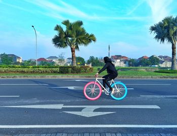 Woman riding bicycle on road