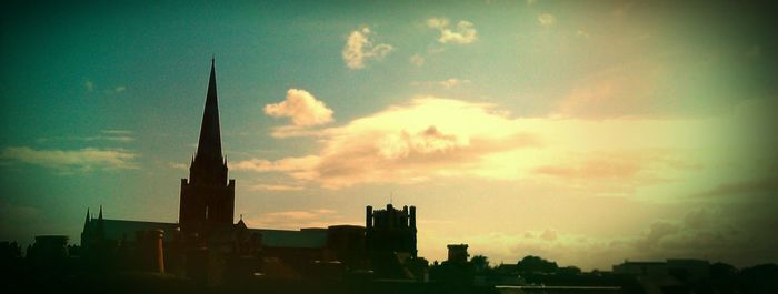 Low angle view of buildings against sky at sunset