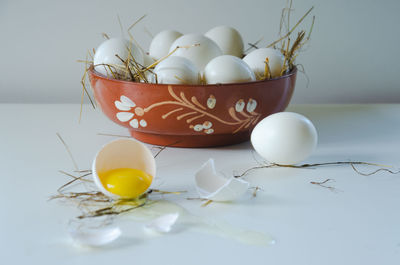 White egg is broken, the shell is on the table. light background