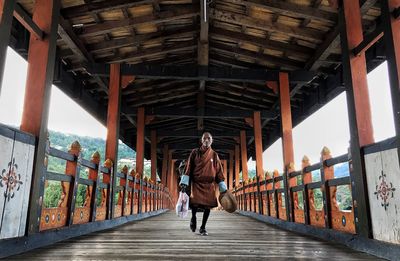 Man walking on footbridge