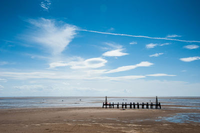 Scenic view of beach against blue sky