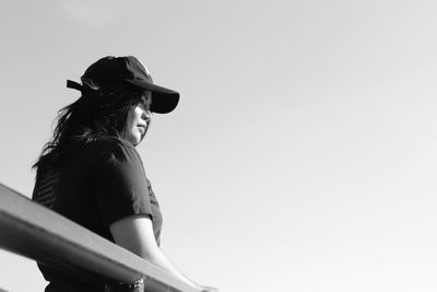 Low angle view of woman against clear sky