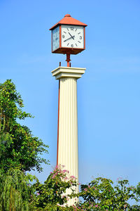 Low angle view of clock tower against blue sky