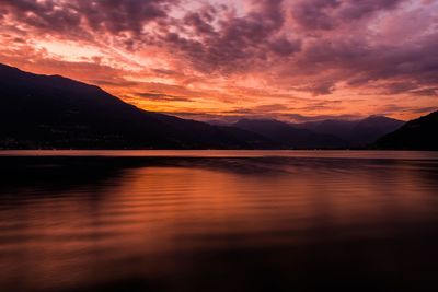 Scenic view of lake against romantic sky at sunset