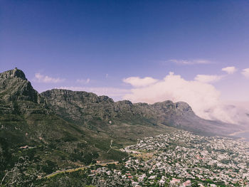 Scenic view of mountains against blue sky