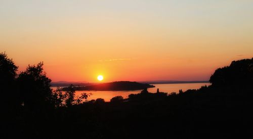 Scenic view of sea against romantic sky at sunset