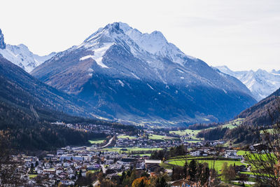 High angle view of townscape and mountains against sky