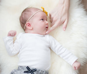 High angle view of baby lying on bed