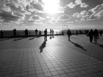 Group of people walking on footpath