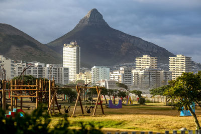 View of cityscape against cloudy sky