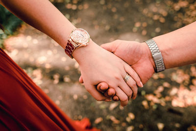 Close-up of couple holding hands