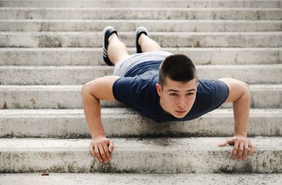 Full length of man exercising on staircase