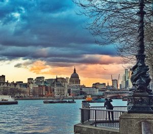 View of cityscape against cloudy sky