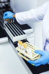 Midsection of scientist working at laboratory