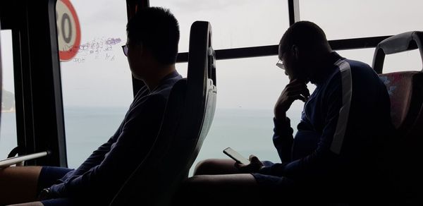Rear view of man sitting in train