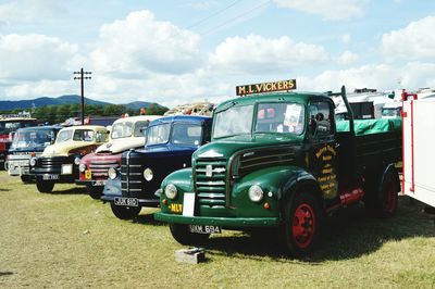 Truck on field against cloudy sky