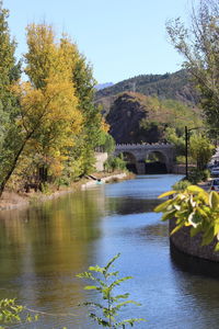 Arch bridge over river against sky