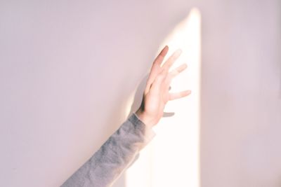 Close-up of woman hand over white background