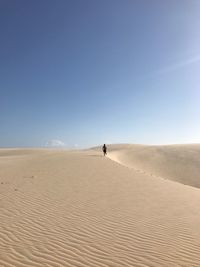 Scenic view of desert against blue sky