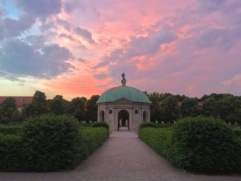 Hofgarten temple amidst park against cloudy sky at sunset