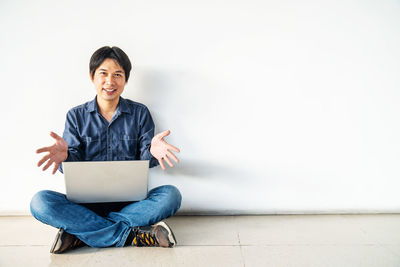 Portrait of smiling young man using mobile phone