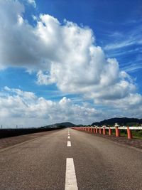 Empty road against cloudy sky