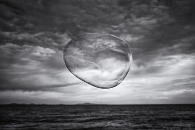 Bubbles in sea against sky