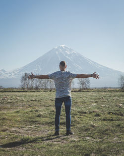 Full length of man standing on field against sky