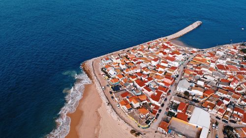 High angle view of sea and buildings in city