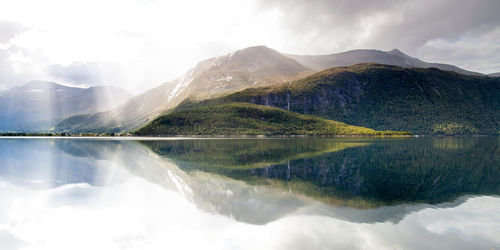 Scenic view of lake against cloudy sky