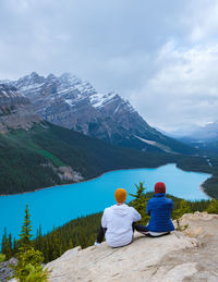 Rear view of man looking at lake