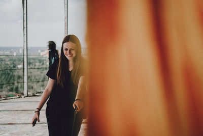 Smiling young woman standing