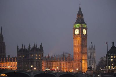 Illuminated big ben in city at dusk