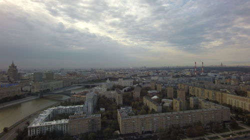 Cityscape against cloudy sky