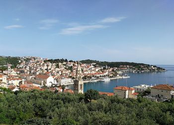 High angle view of townscape by sea against sky