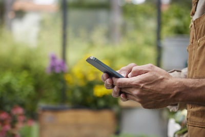 Midsection of woman using mobile phone