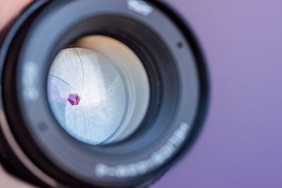 Close-up of camera against purple background