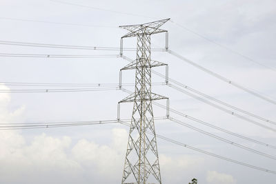 Low angle view of electricity pylon against sky