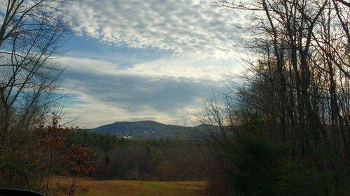 Scenic view of mountains against cloudy sky