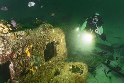 Diver exploring wreck at raja yai close to phuket