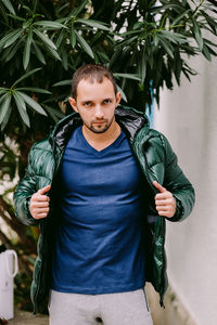 Portrait of man wearing jacket standing outdoors