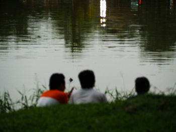 People sitting on lake