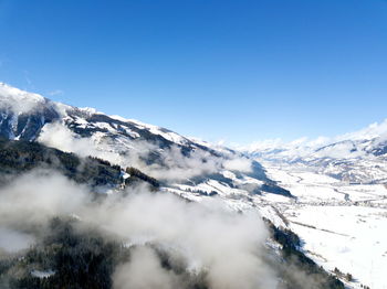 Scenic view of snow covered mountains against sky